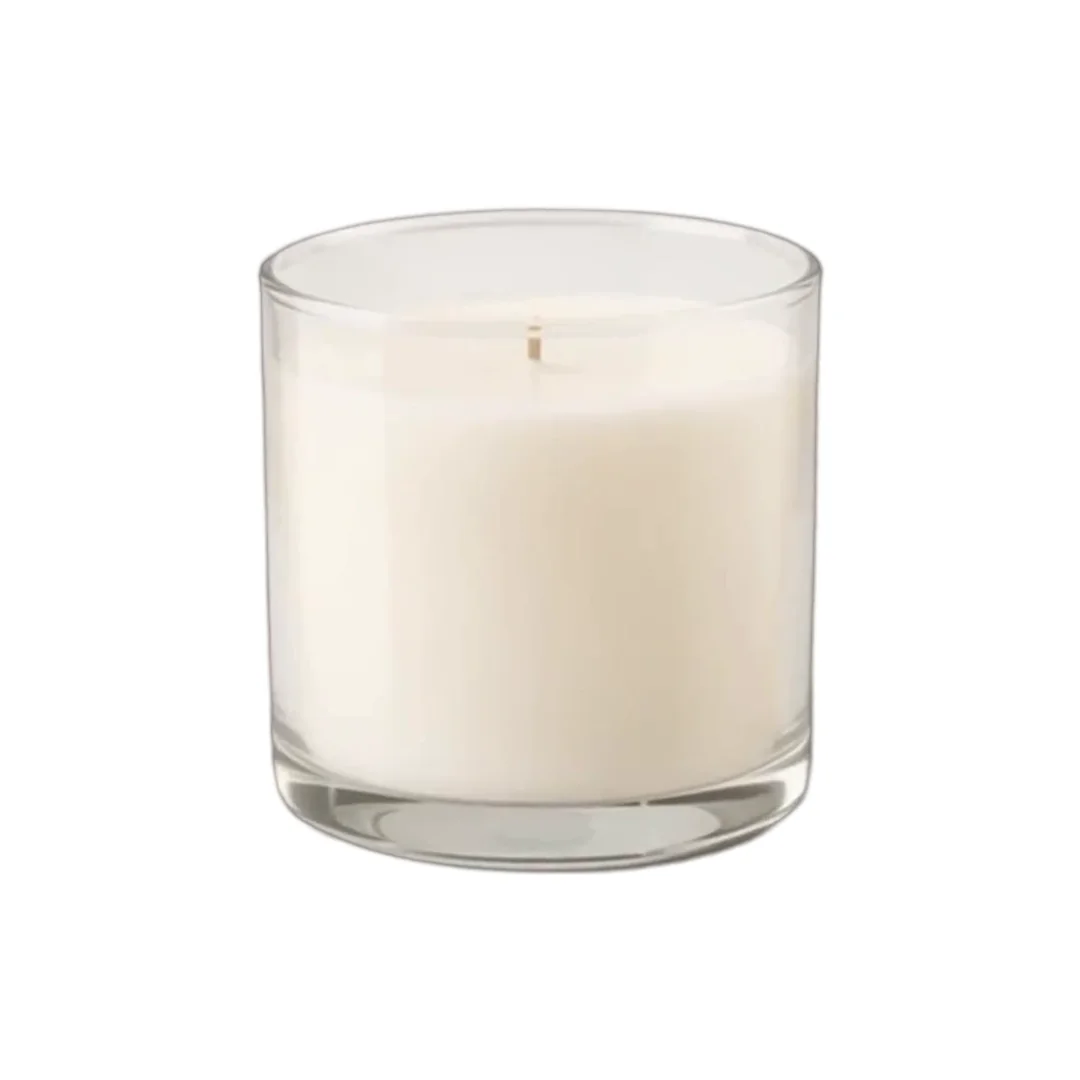 A white candle in a clear glass on a plain white background, the catalog photo as it comes out of the store