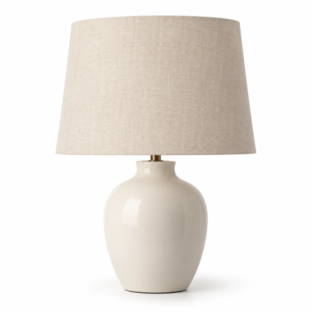 A cream ceramic table lamp on a plain white background, the catalog photo as it comes out of the store